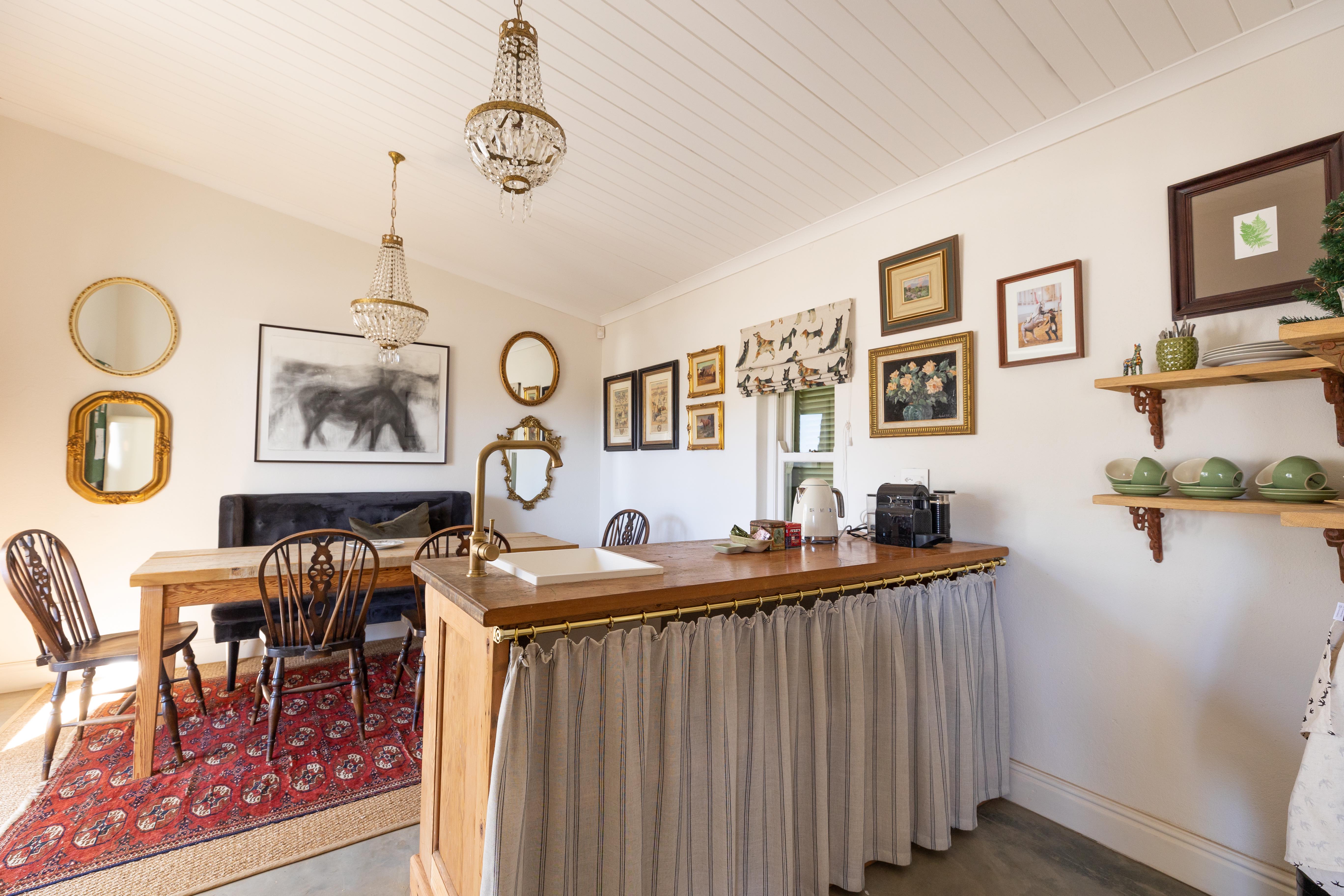 Tea room kitchen area with antique furnishings and artwork