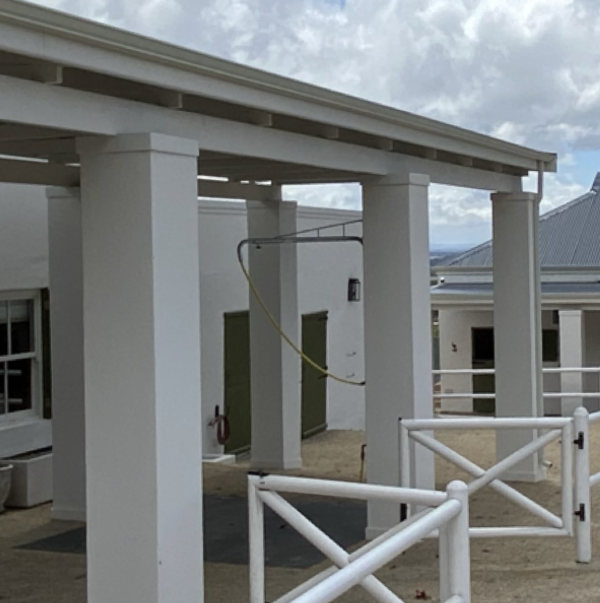 Covered hot and cold water washbay facility with professional plumbing and drainage